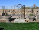 classic pool fence with an arched, decorative gate 
