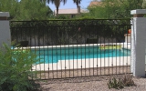 3-rail decorative pool fence mounted between masonry columns