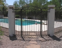 the arched decorative gate with 3-rail pool fence